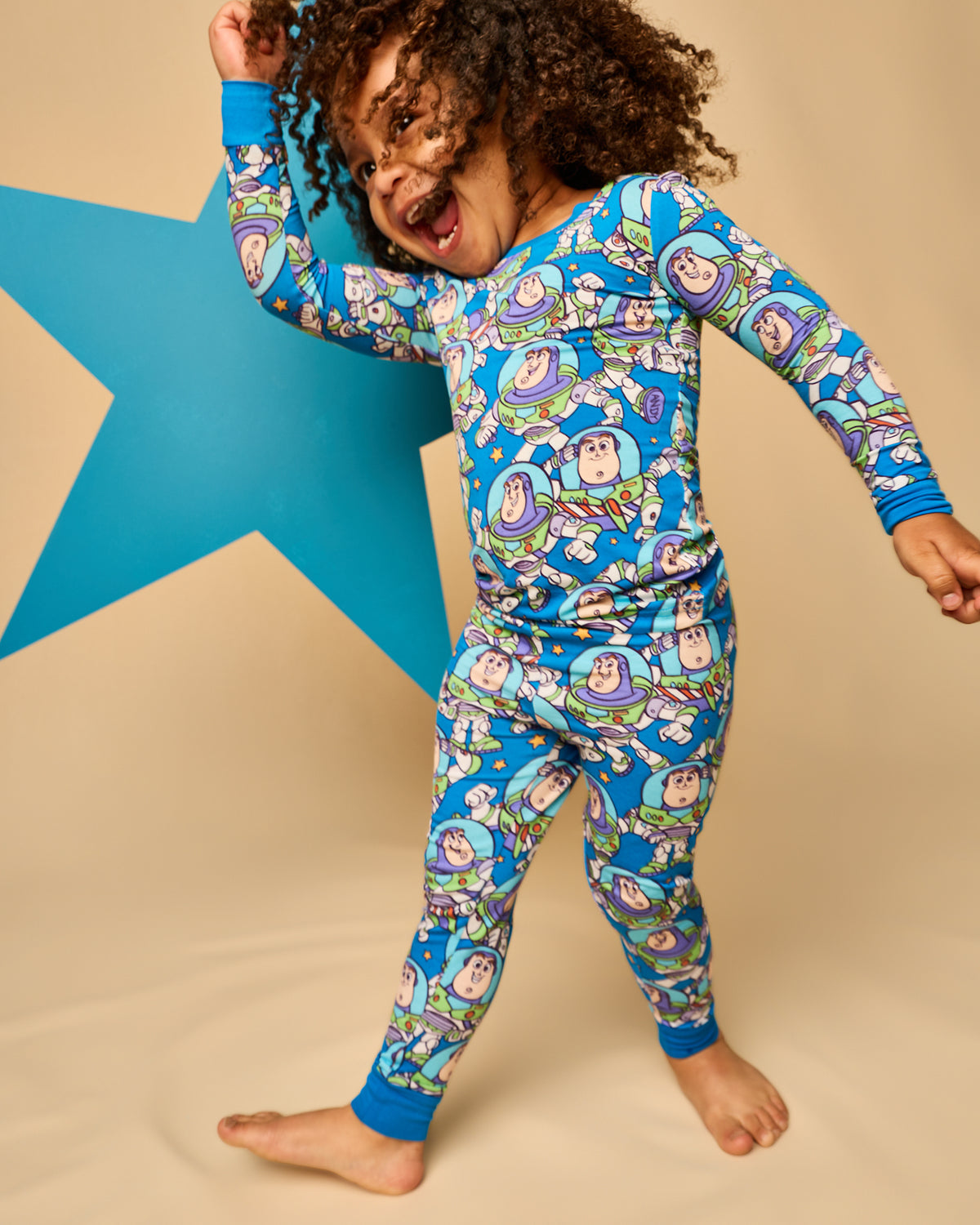 Child in motion wearing the Disney & Pixar Buzz's Cosmic Crew Two-Piece Pajama Set