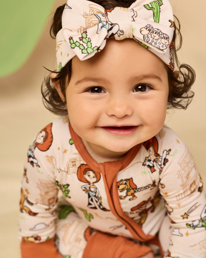Baby wearing the Disney & Pixar Woody's Wild West Luxe Bow Headband