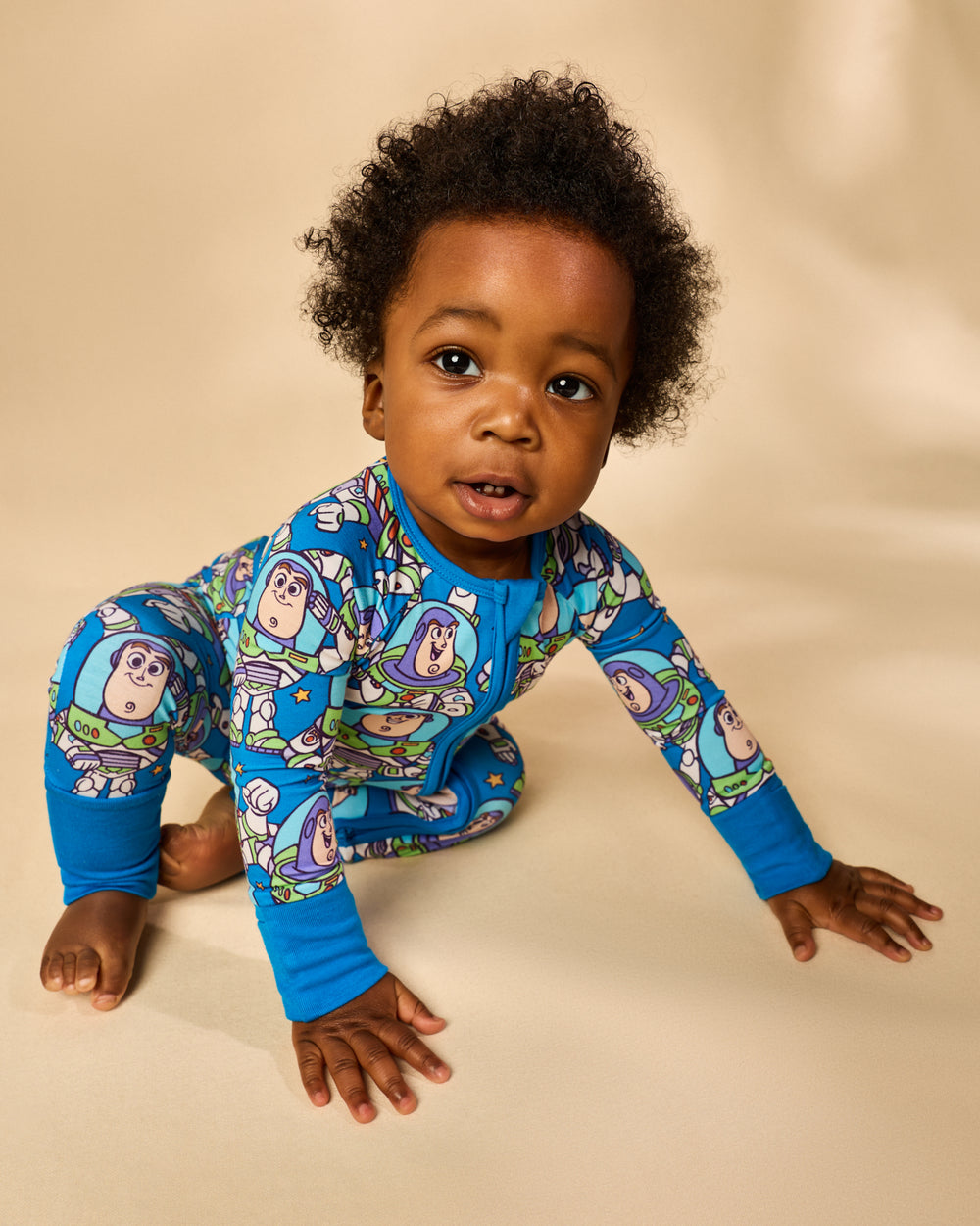 Crawling baby wearing the Disney & Pixar Buzz's Cosmic Crew Zippy