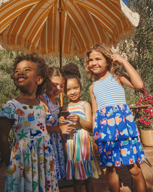 Three girls wearing Summer Dresses on a patio