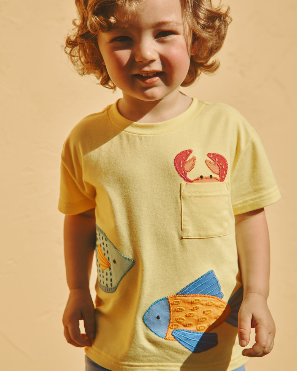 Boy wearing the School of Friends Relaxed Pocket Tee on a yellow backdrop