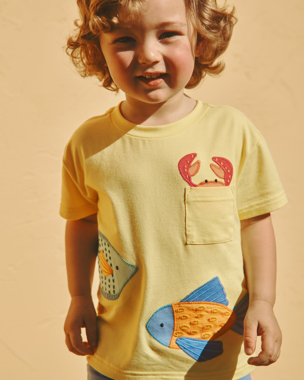 Boy wearing the School of Friends Relaxed Pocket Tee on a yellow backdrop