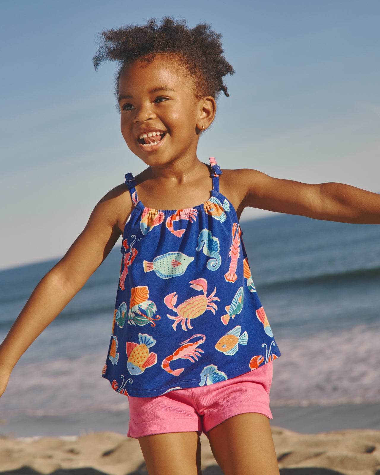 Girl wearing the Tidepool Party Bow Strap Tank at the beach