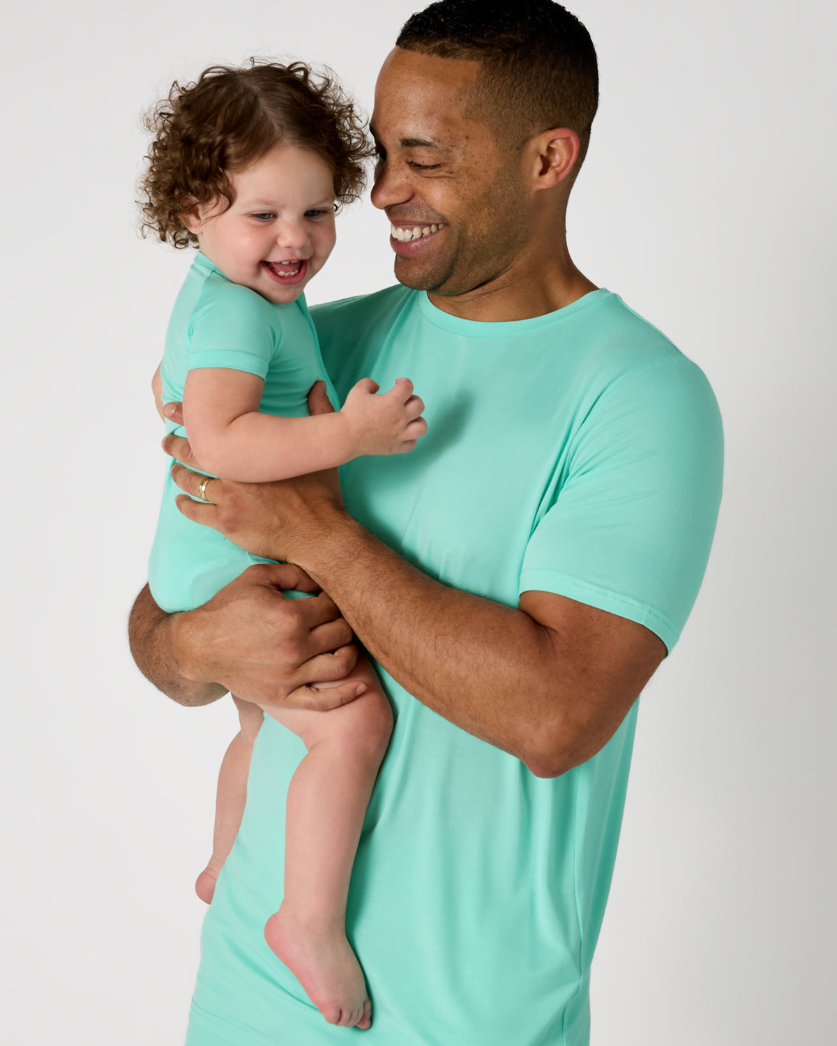 Father and child wearing matching Ocean Mist pajamas