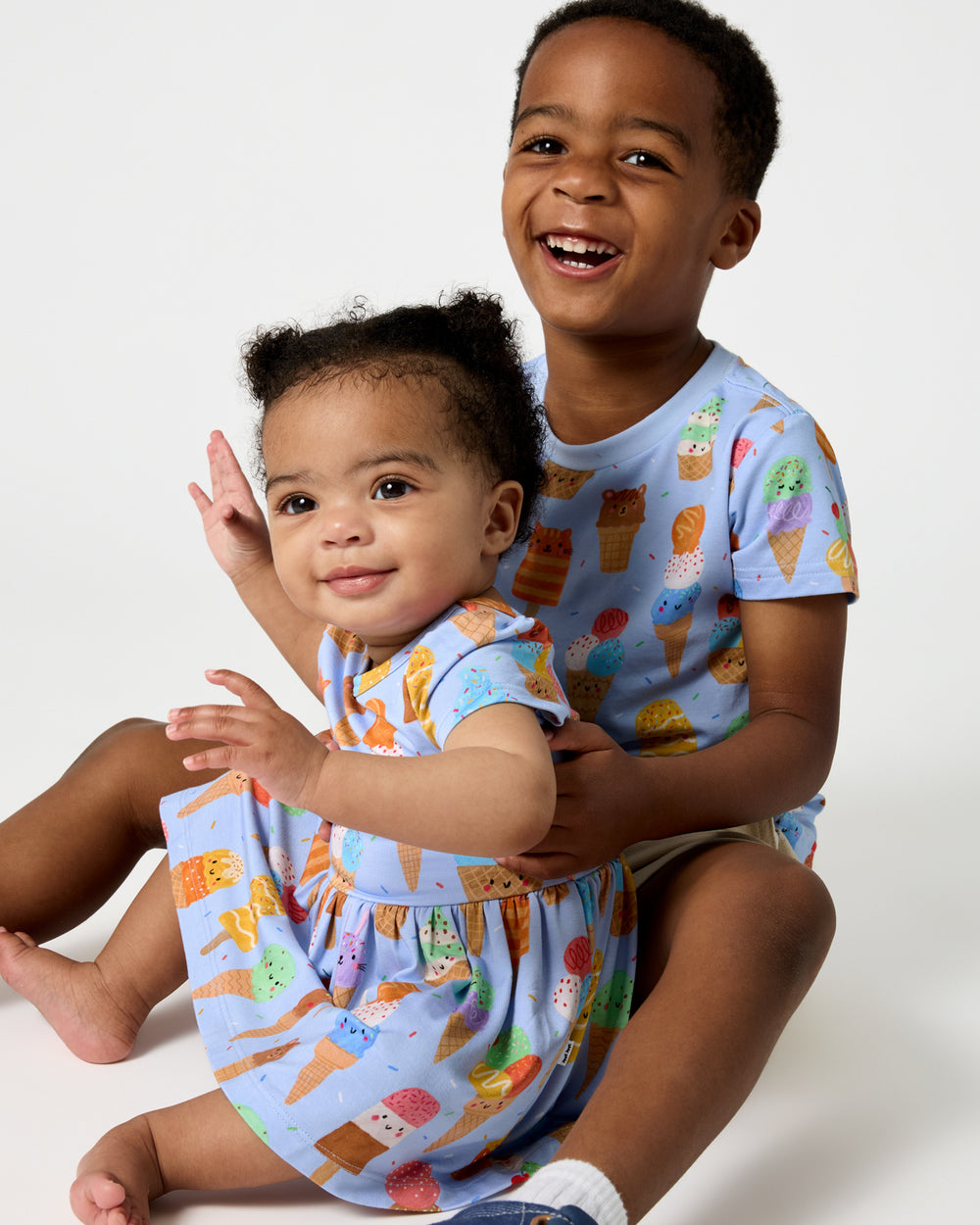 Two children wearing matching Scoop Squad daywear styles