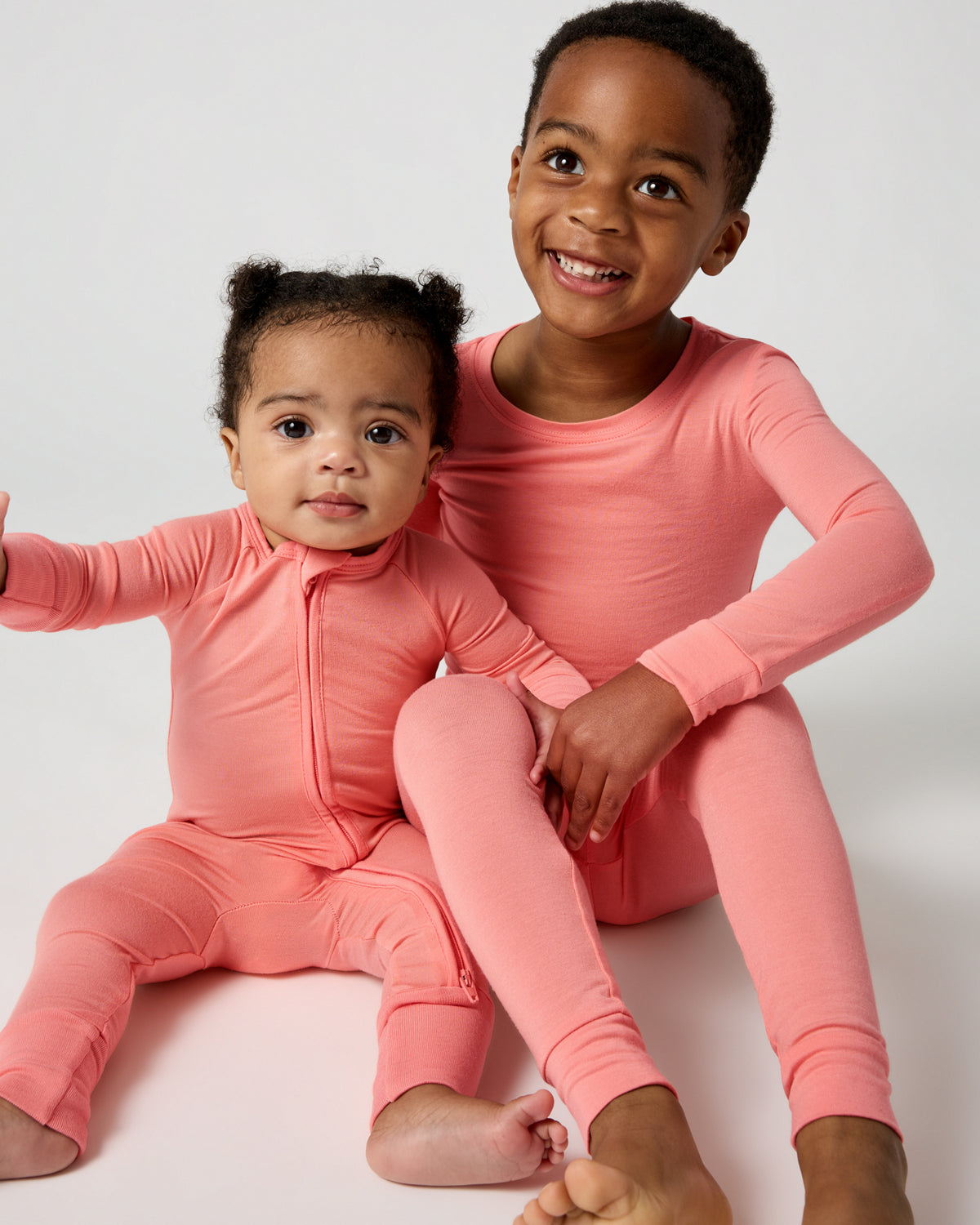 Two children wearing matching Sweet Papaya Pajamas
