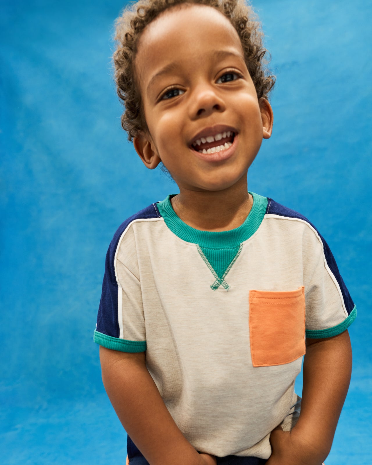 Boy wearing the Linen Heather Relaxed Pocket Tee on a blue back drop