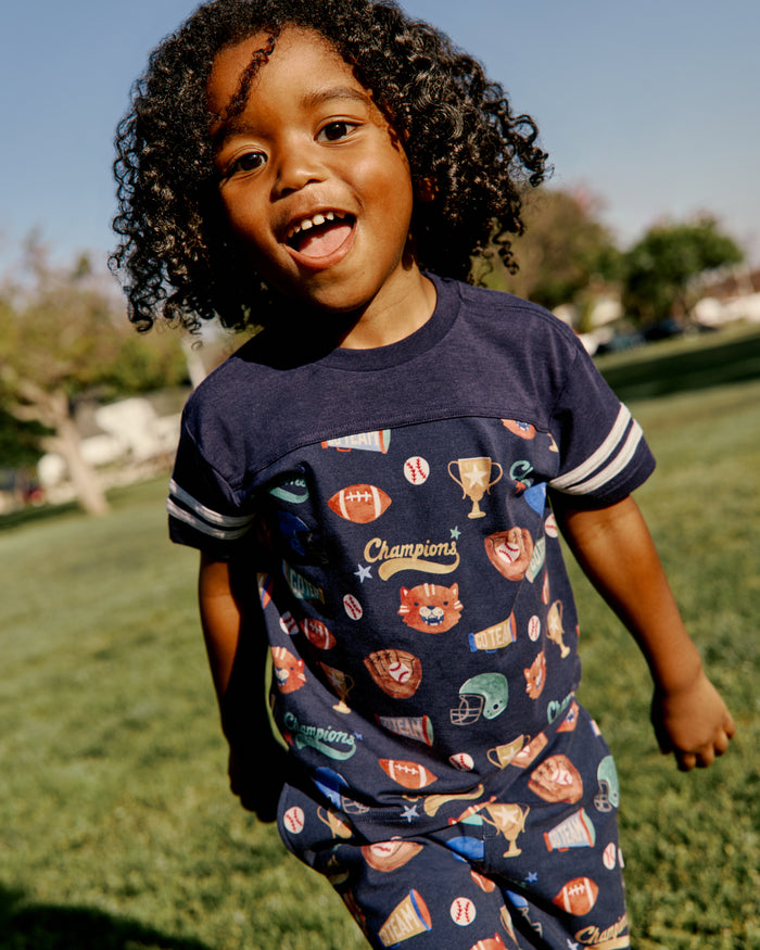 Boy wearing the Team Spirit Relaxed Tee on a grassy field