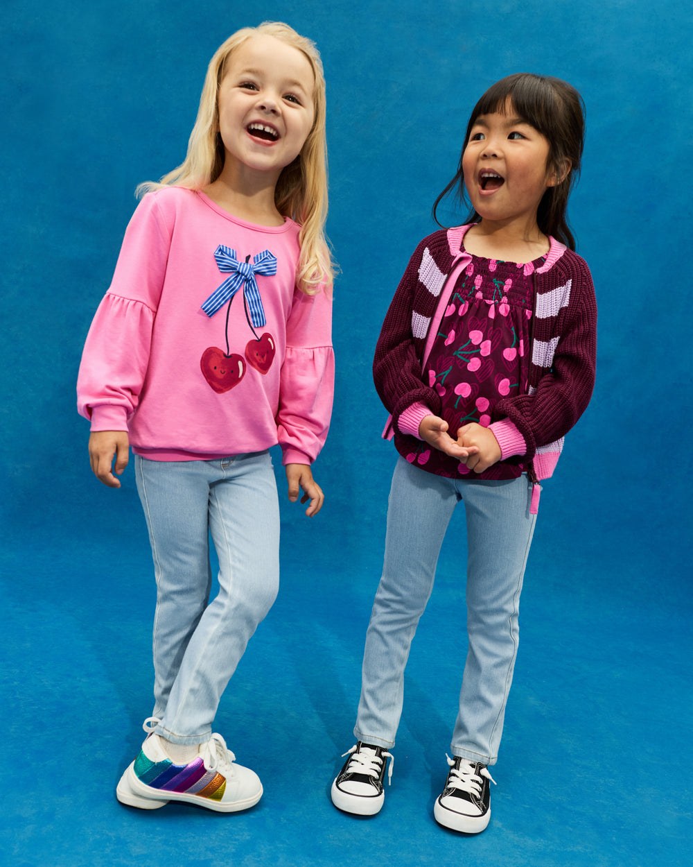 Two girls wearing Cherry tops with denim pants