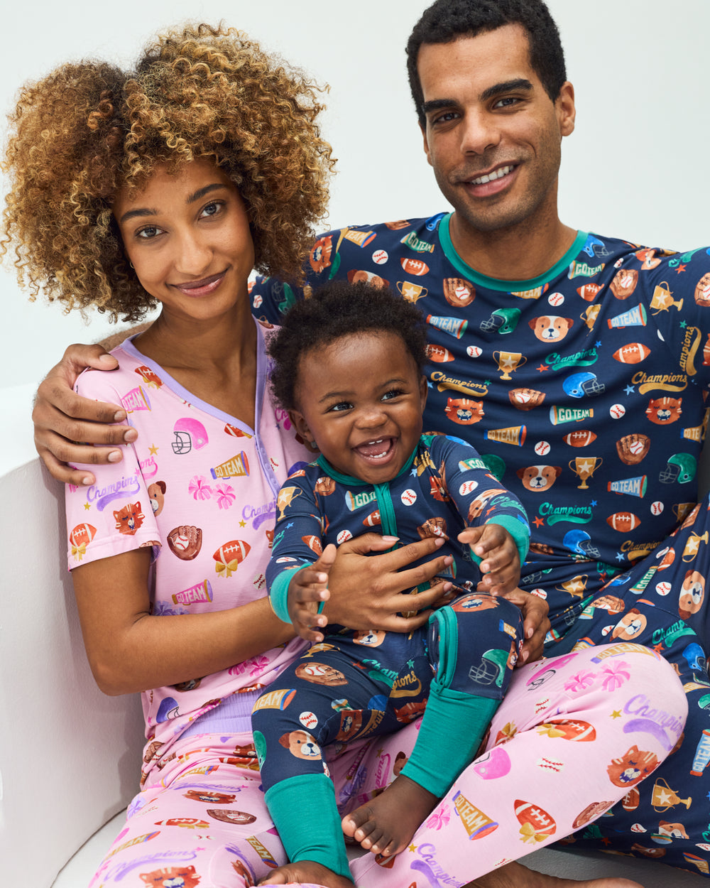 Close up family of three wearing matching Team Spirit PJs