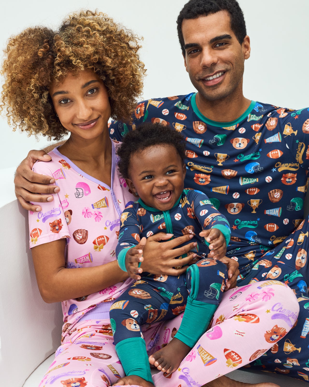 Close up family of three wearing matching Team Spirit PJs
