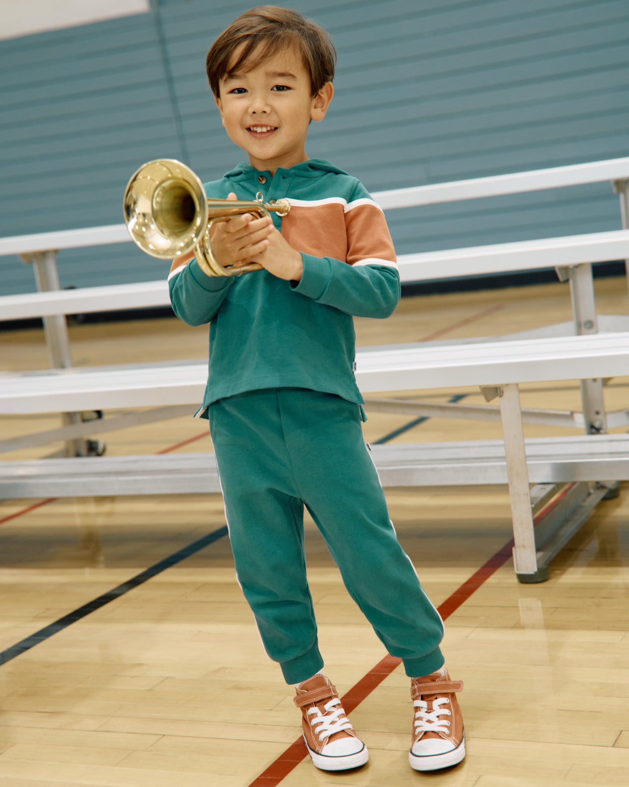 Boy wearing the Emerald Isle Relaxed Jogger and Hoodie in a gymnasium