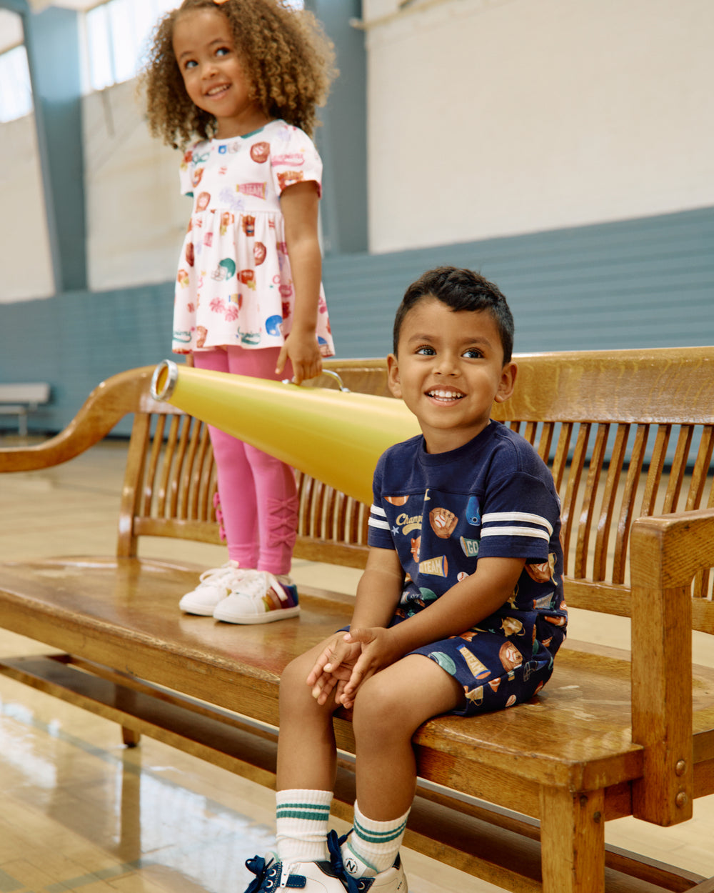 Two children wearing Team Spirit styles in a gymnasium 