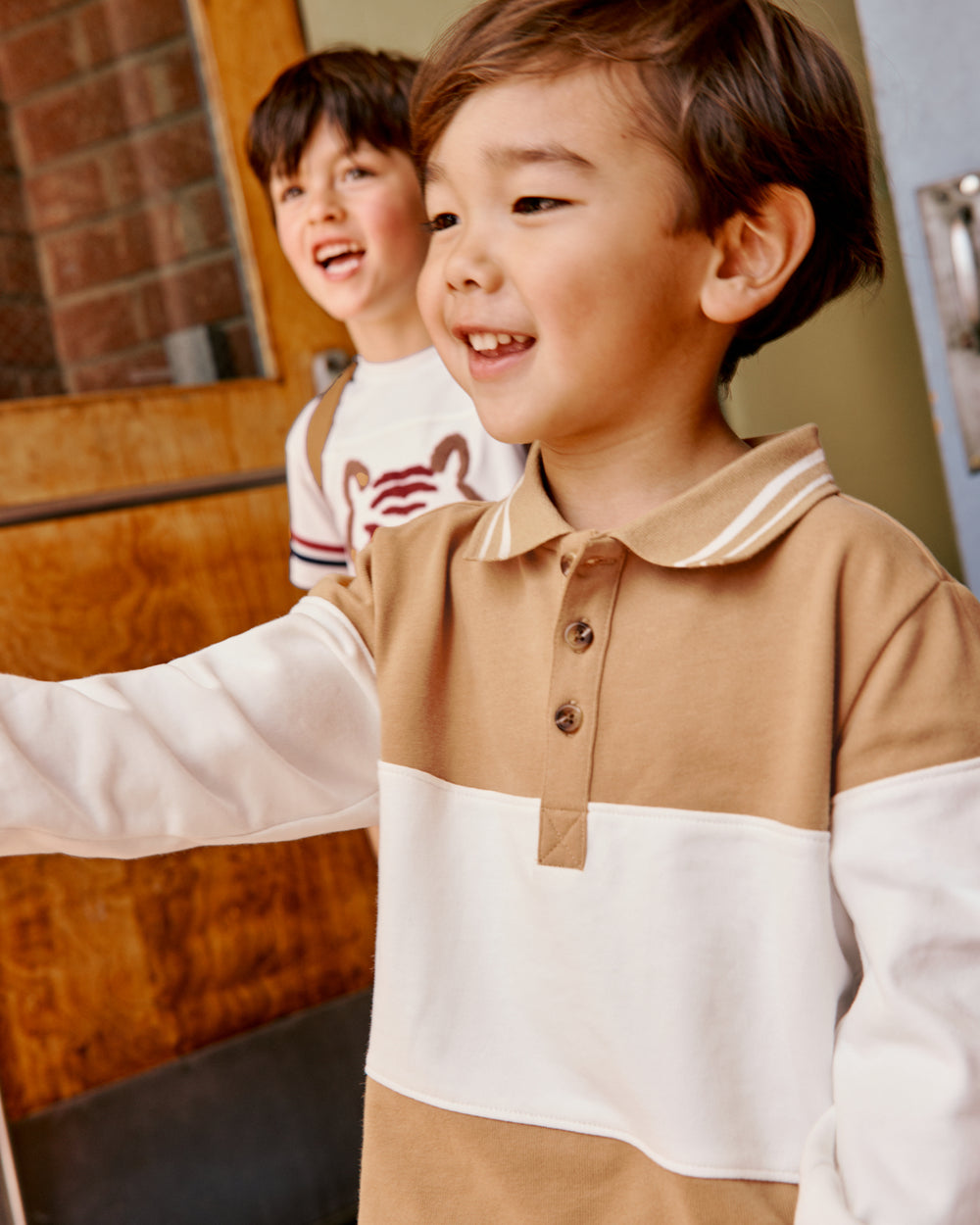 Close up of boy wearing the Maple Cream Rugby Shirt in a school