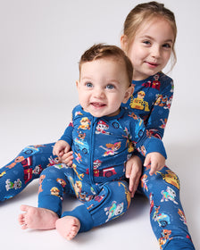 Two children wearing matching PAW Patrol Adventure Bay Heroes Pajamas