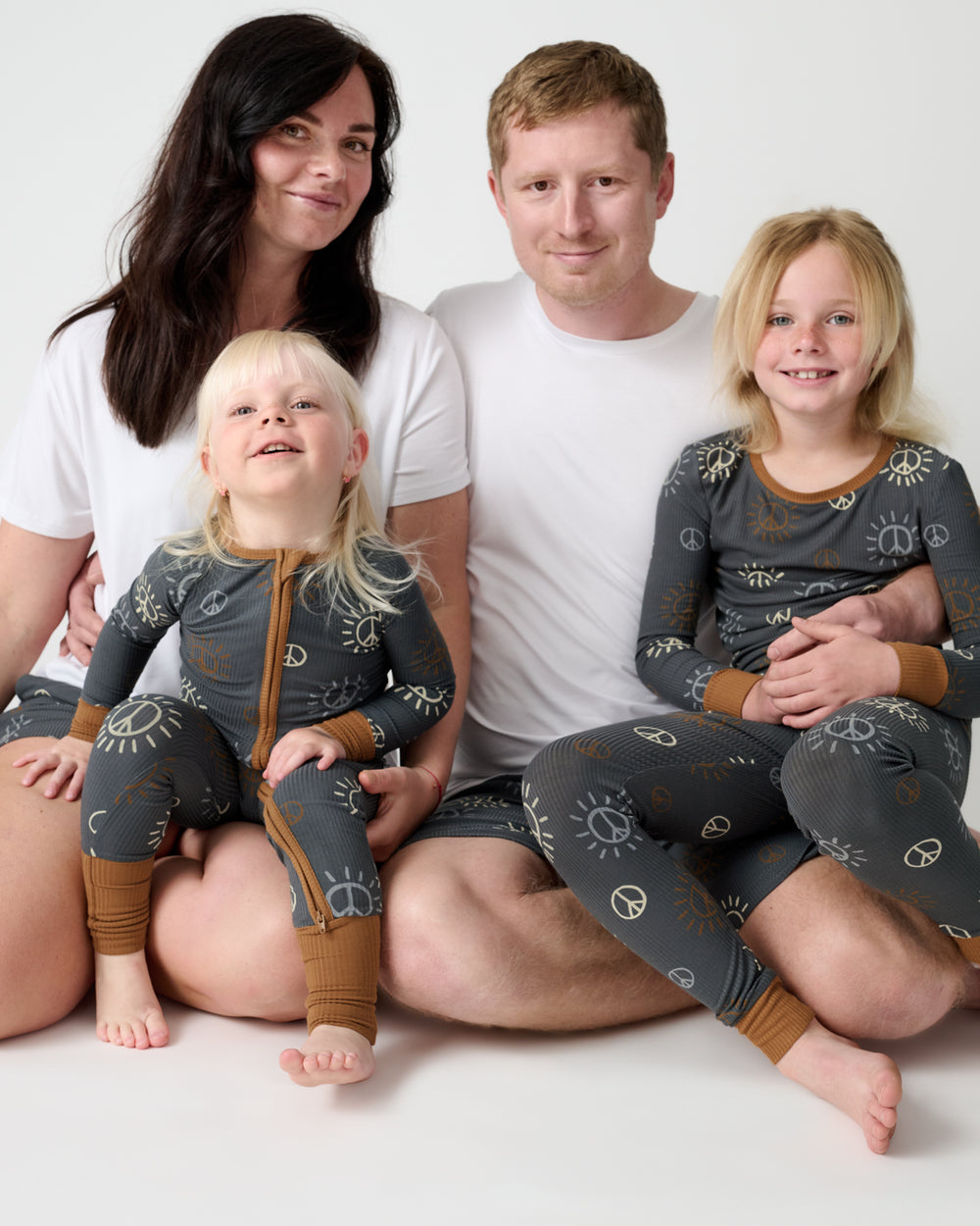 Family of four wearing matching Peace & Love Ribbed Pajamas