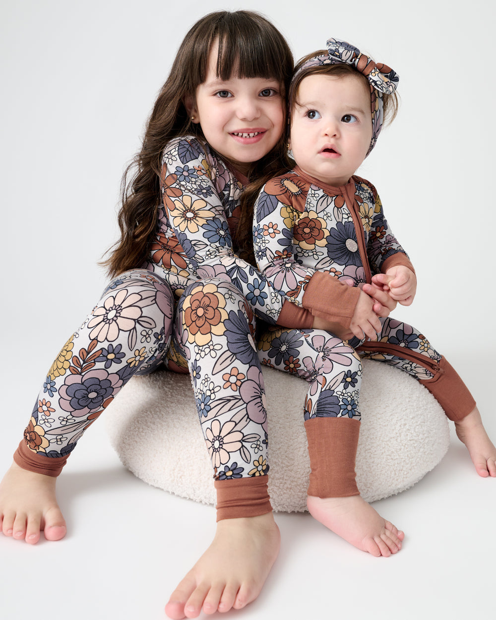 Two children wearing matching Wildwood Floral Pajamas