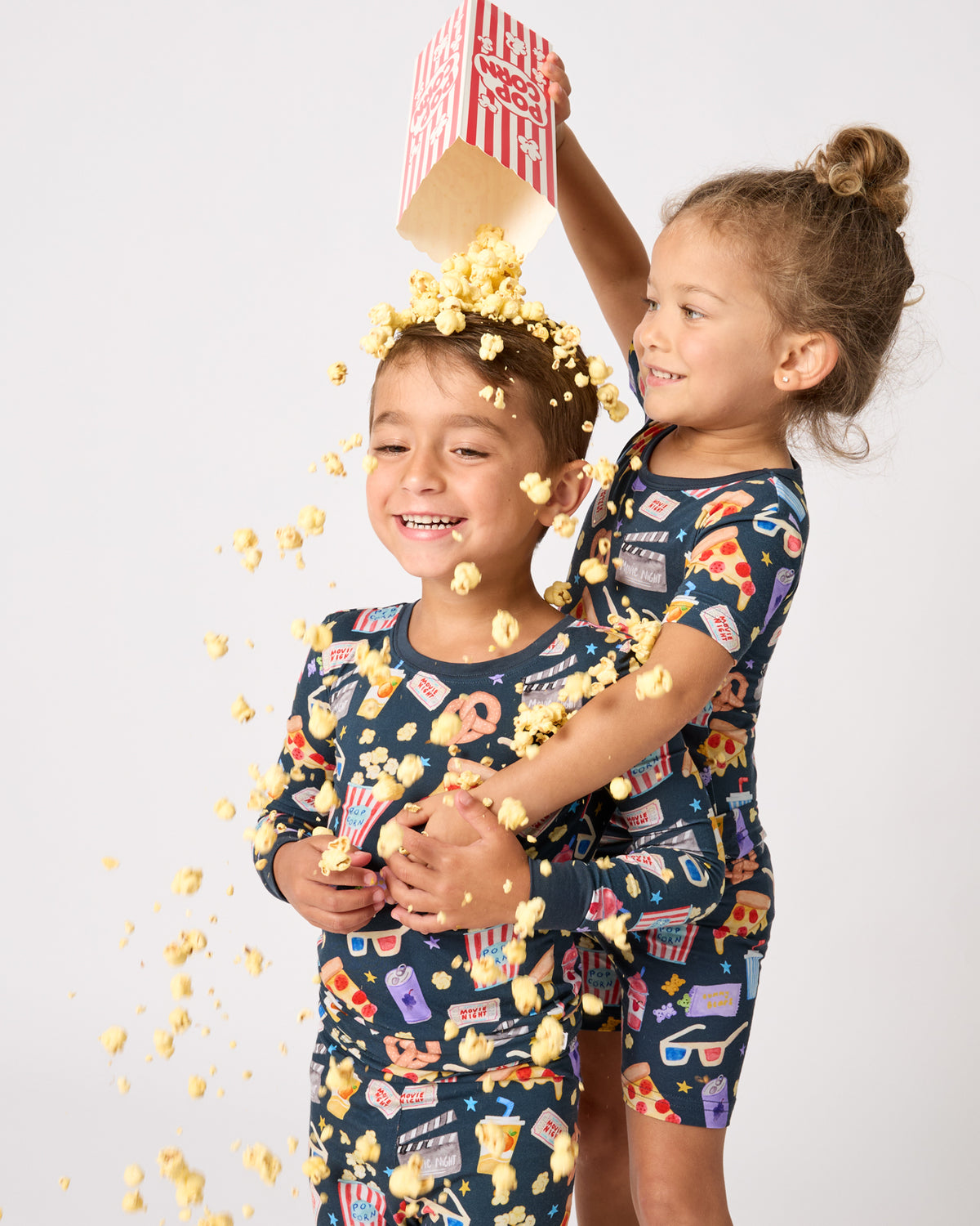 Two children wearing Movie Marathon Two-Piece PJ Sets
