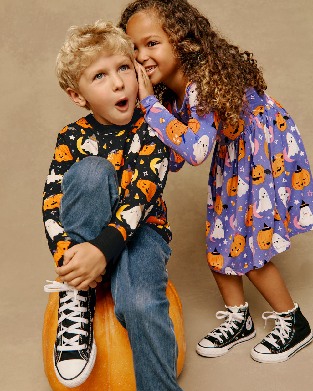Two children wearing matching Moonlit Magic Halloween styles