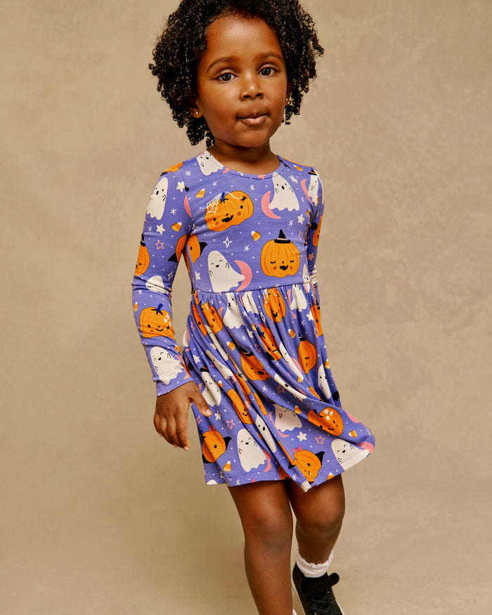 Girl wearing the Moonlit Magic Purple Bow Back Skater Dress