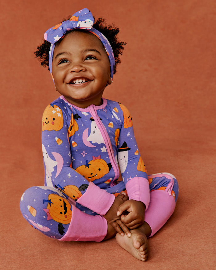 Baby girl wearing the Moonlit Magic Purple Luxe Bow Headband and Zippy