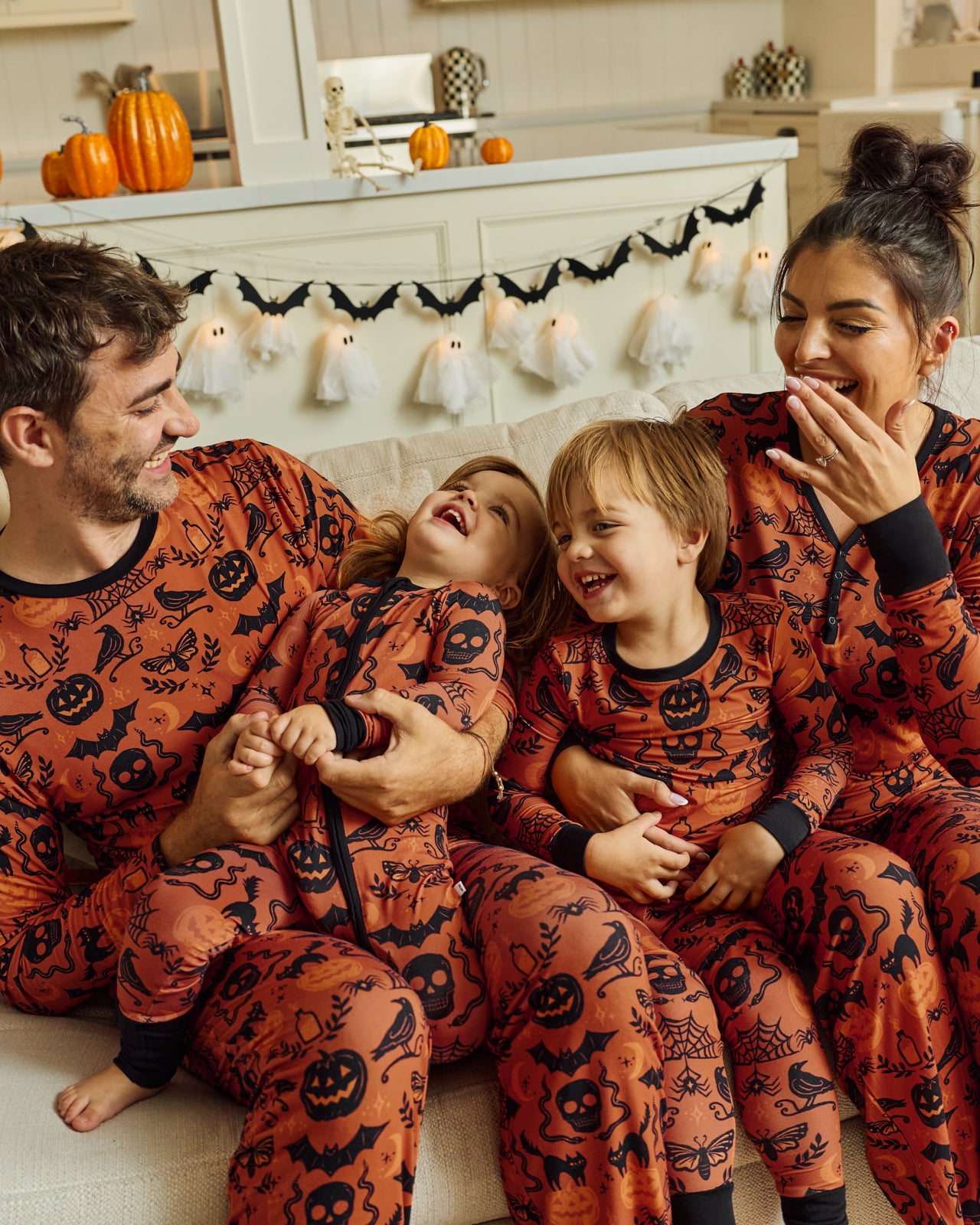 Family of four wearing matching Midnight Mischief Pajamas