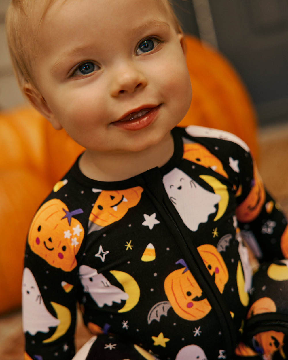 Close up of baby wearing the Moonlit Magic Halloween Print Zippy