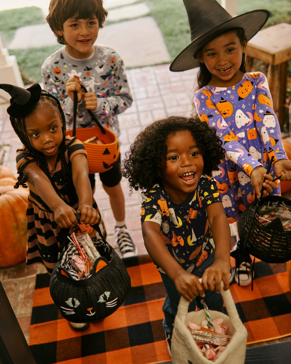 Four children wearing Halloween play styles from Little Sleepies