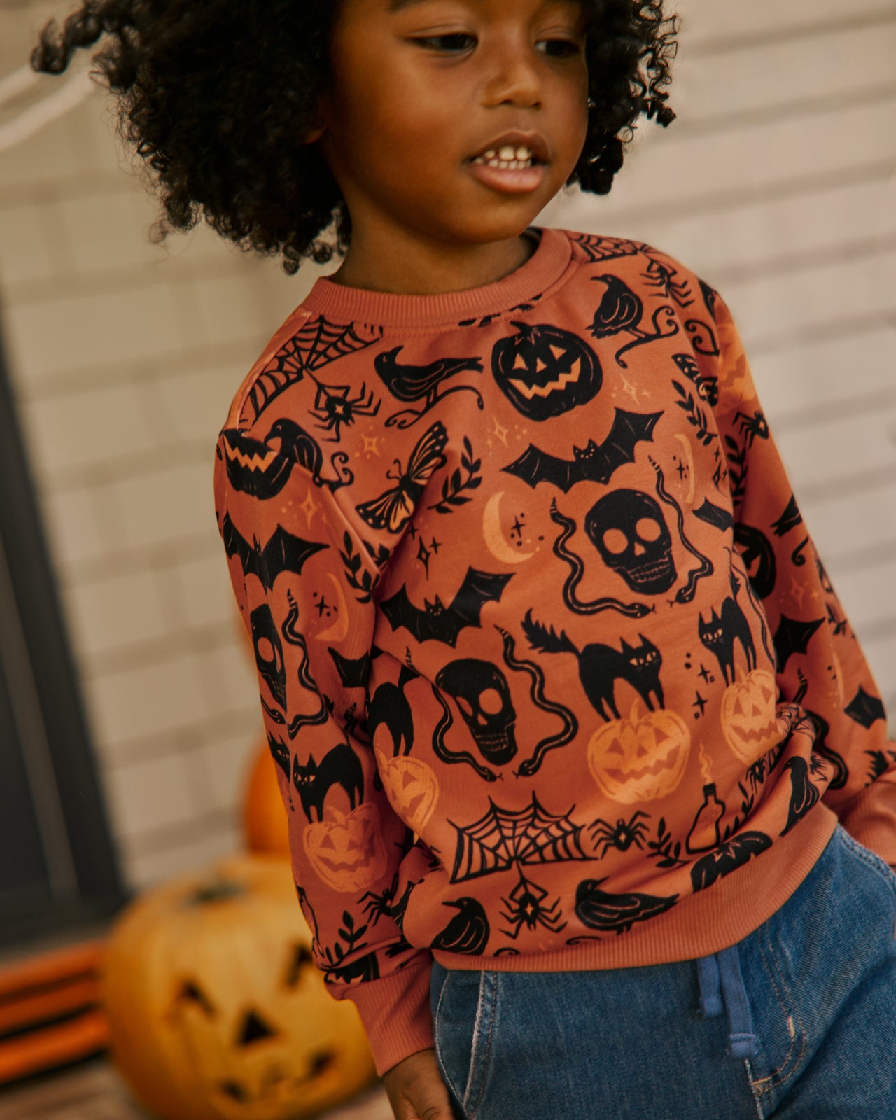Boy wearing the Midnight Mischief Crewneck Sweatshirt with denim pants