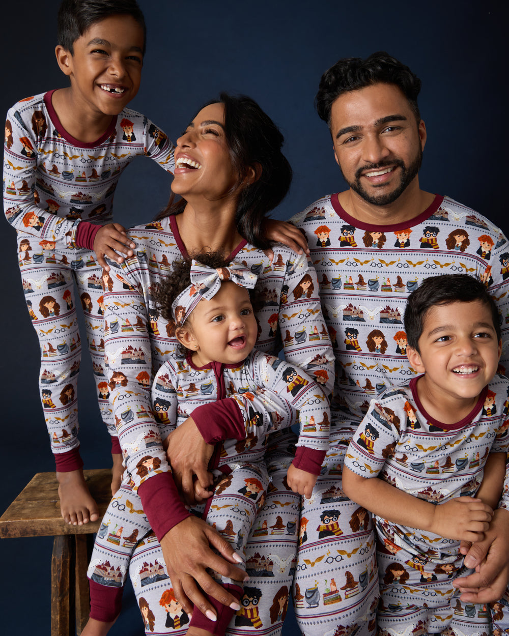 Family of five wearing matching Harry Potter™ Spellbinding Studies PJs