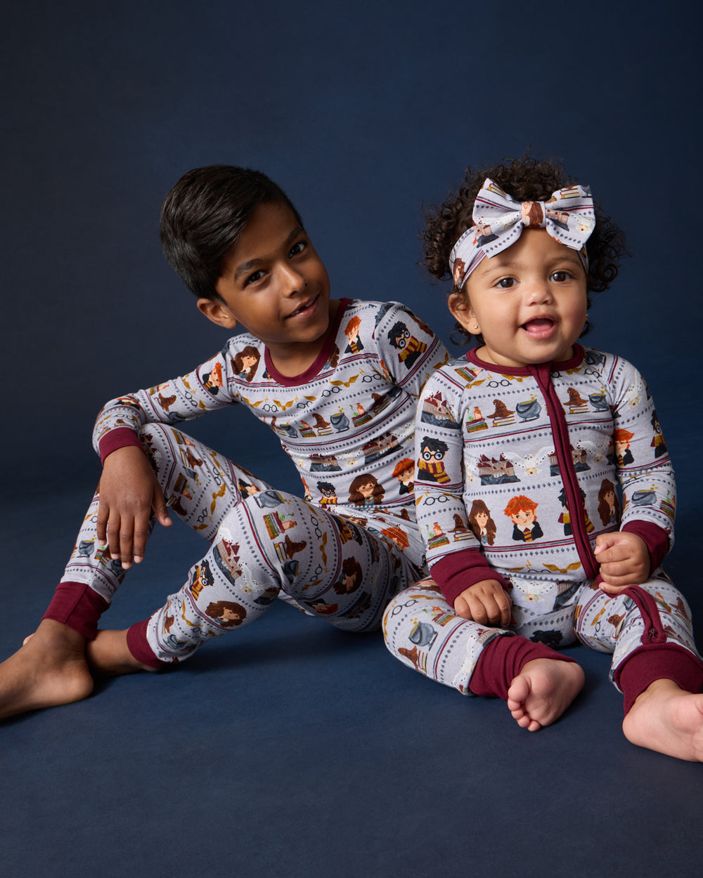Two children wearing matching Harry Potter™ Spellbinding Studies PJs