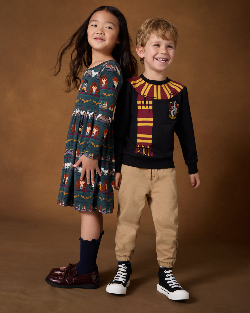 Two children wearing daywear styles from the Harry Potter™ Spellbinding Studies collection