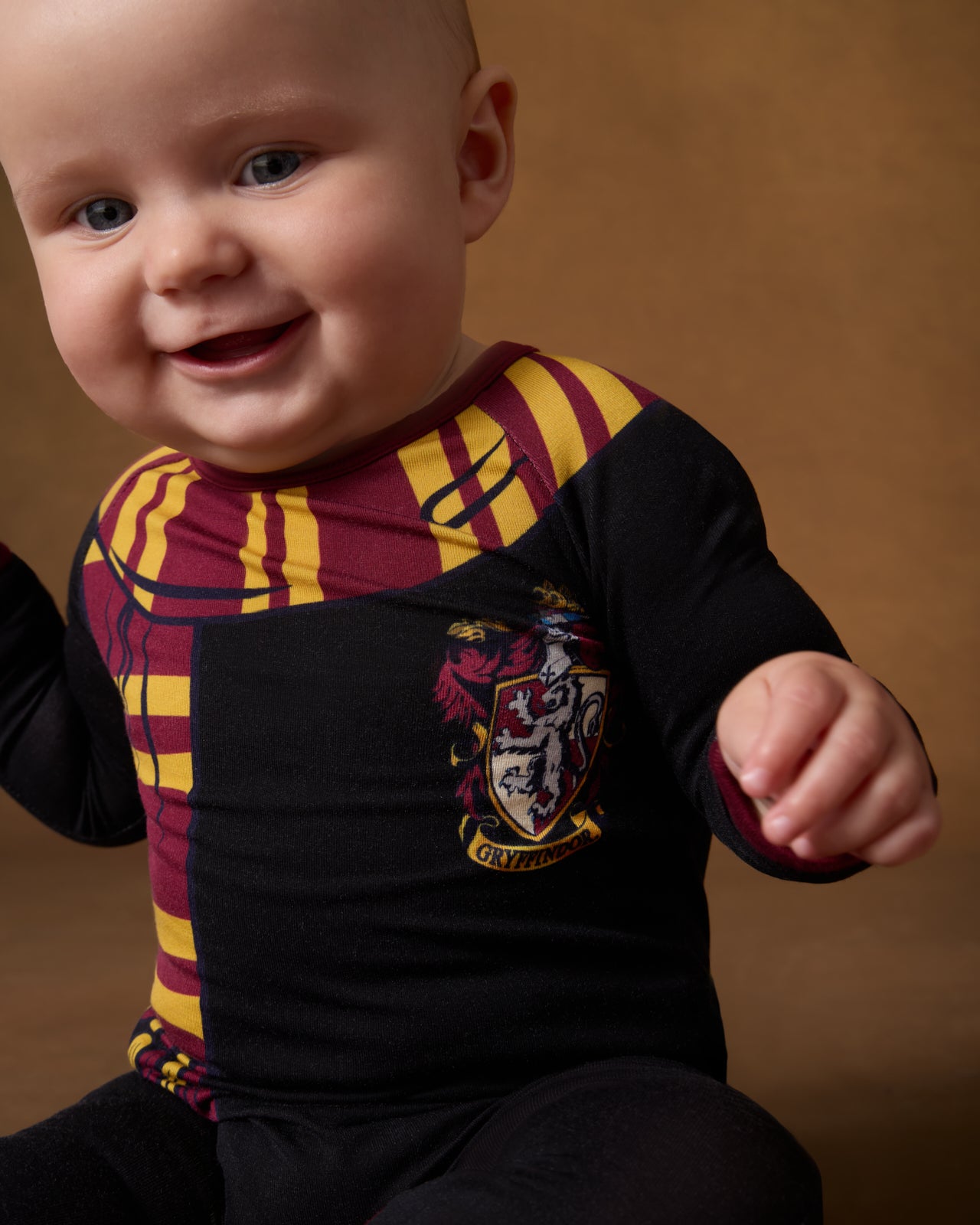 Close up of baby wearing the Harry Potter™ Gryffindor Crescent Zippy