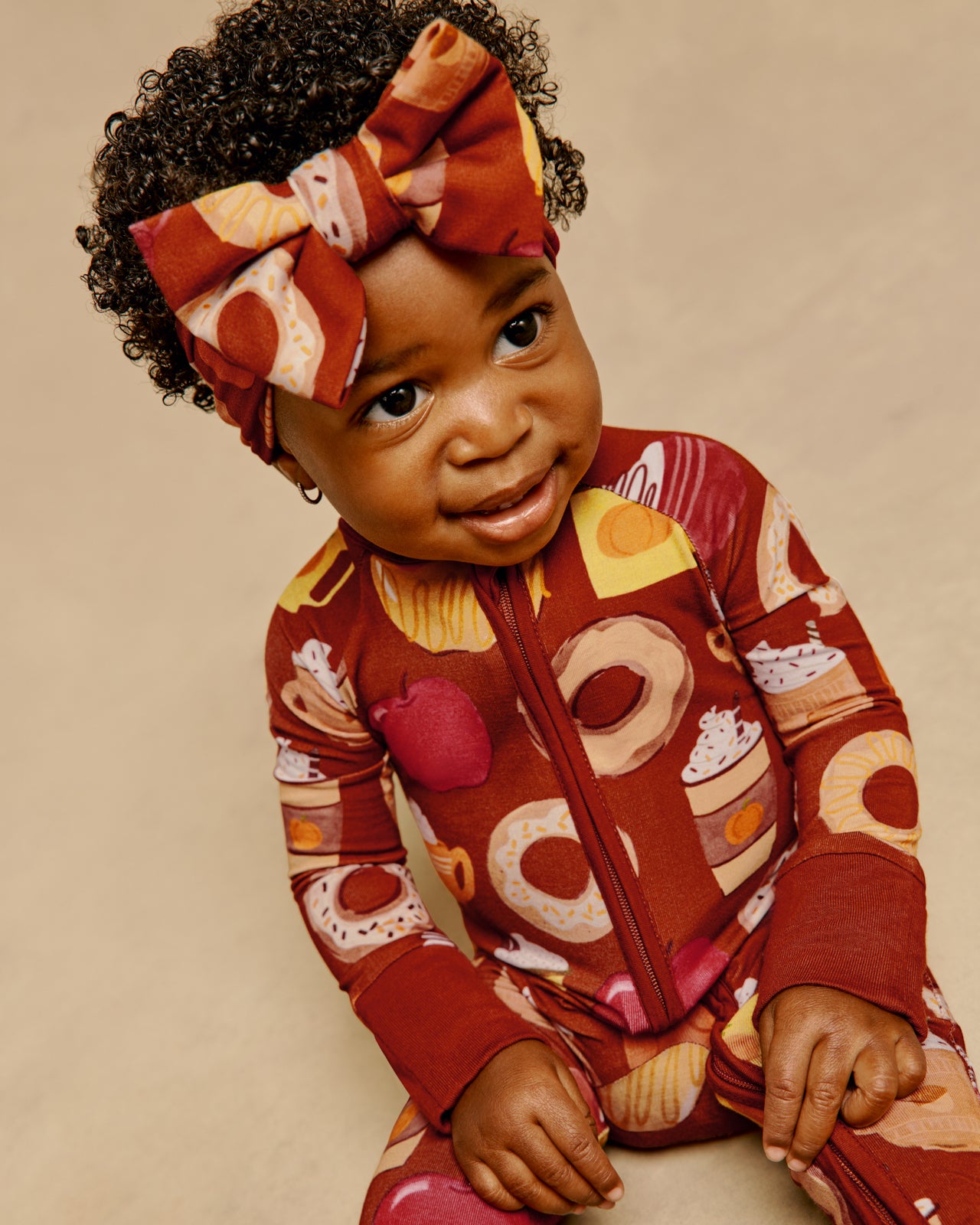 Sitting baby wearing the Harvest Sweets Luxe Bow Headband and Zippy