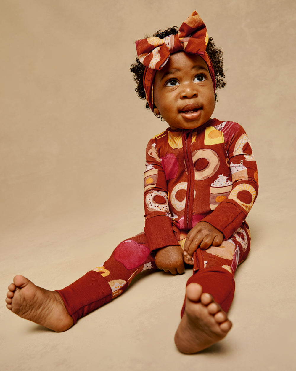 Sitting baby wearing the Harvest Sweets Zippy and Luxe Bow Headband