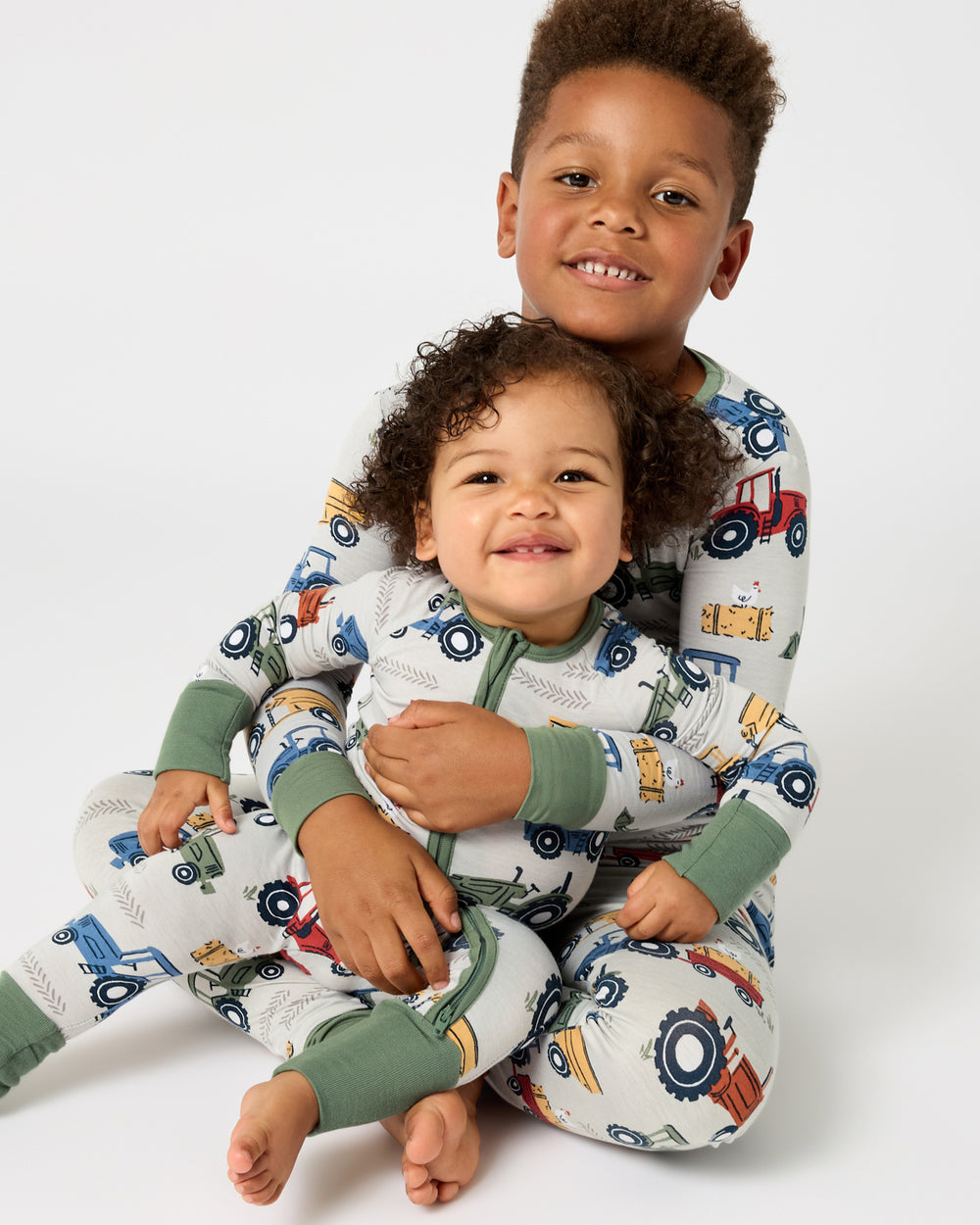Two children wearing matching Tractor Tales PJs