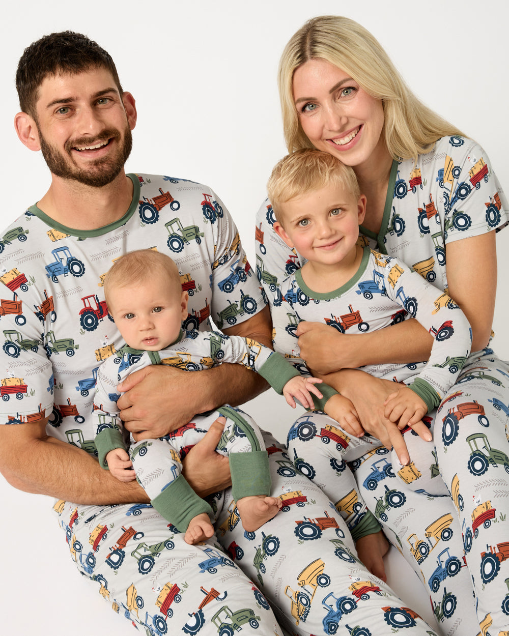 Family of four wearing matching Tractor Tales bamboo pajamas