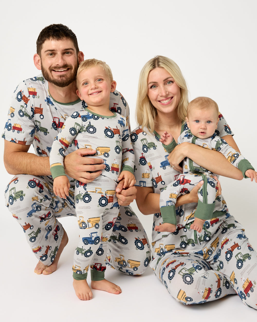 Family of four wearing Tractor Tales bamboo pajamas