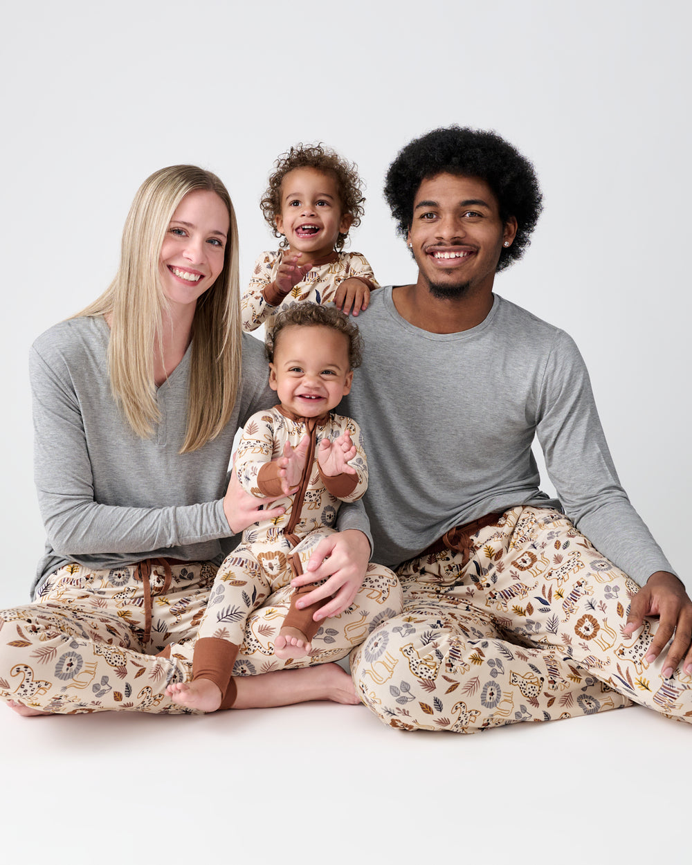 Family of four wearing matching Savanna Friends pajamas
