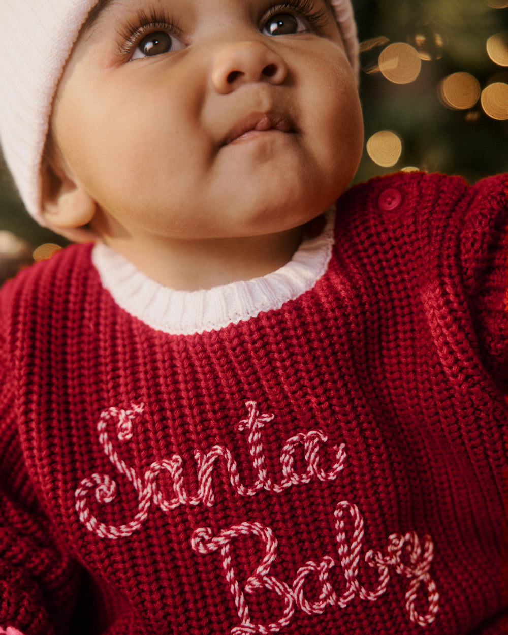 Close up of newborn wearing the Santa Baby Sweater