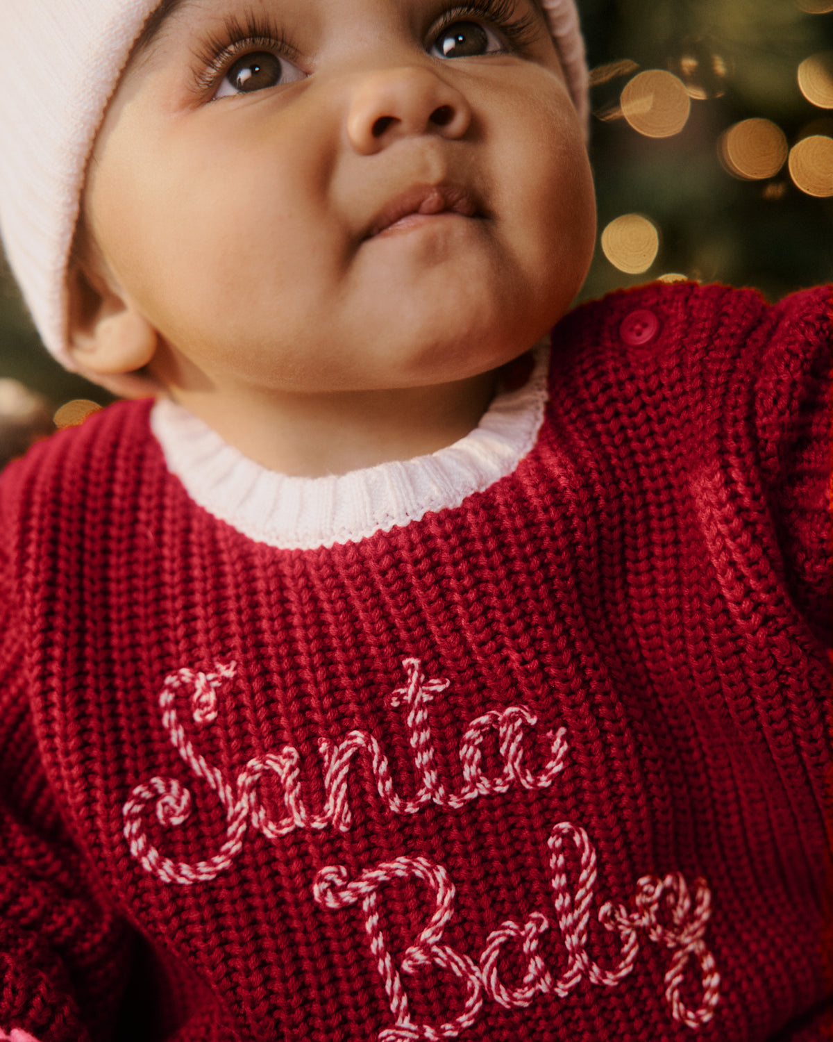 Close up of newborn wearing the Santa Baby Sweater