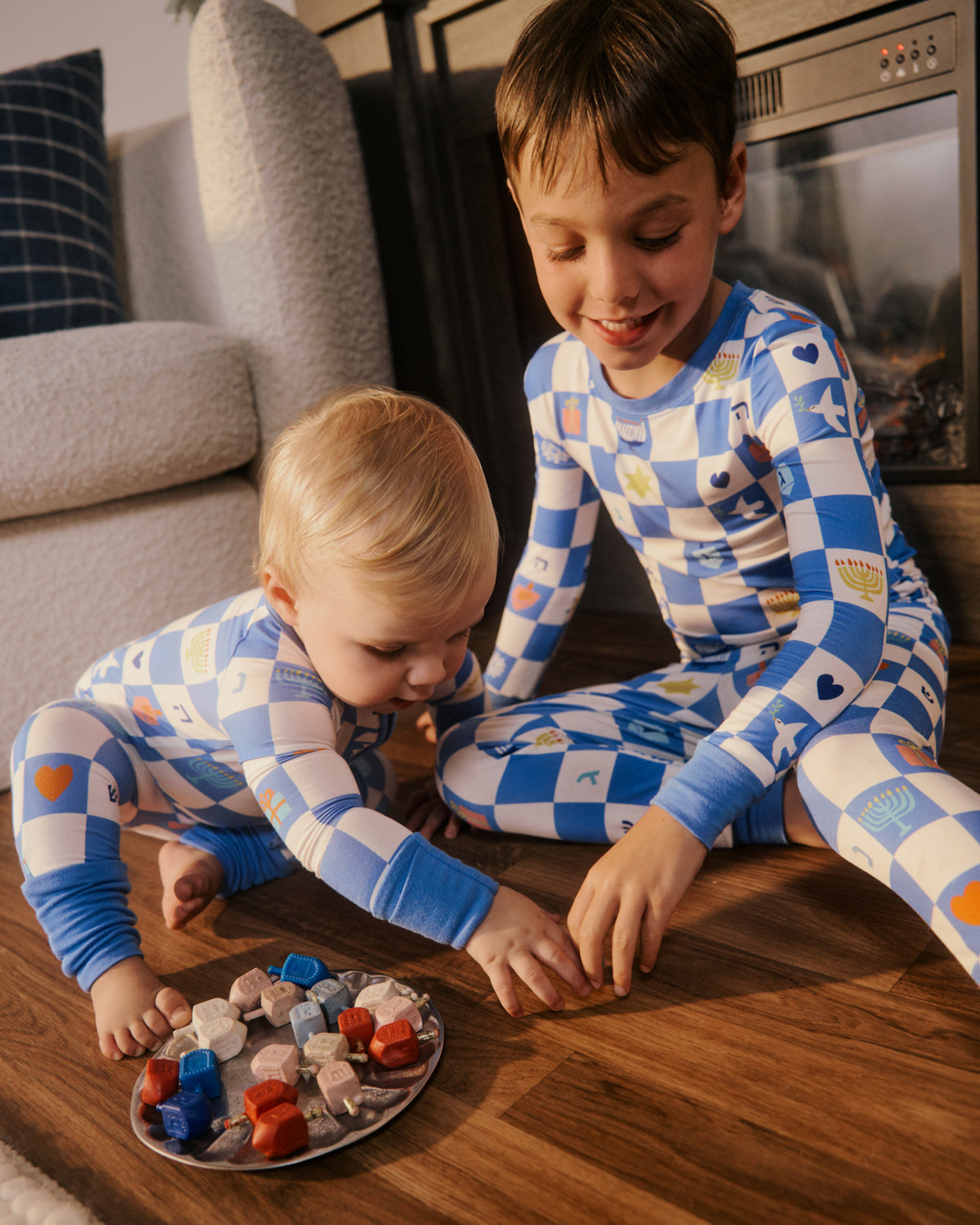 Two children wearing matching Hanukkah pajamas