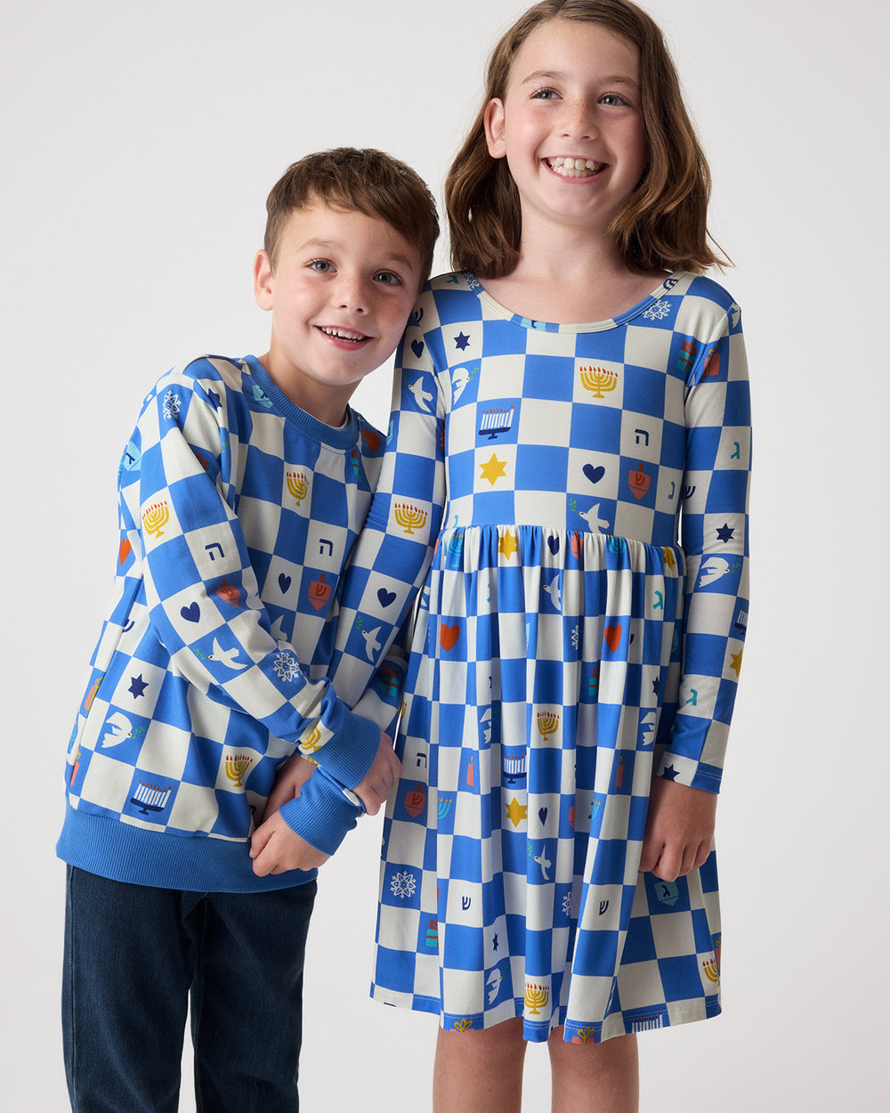 Two siblings wearing matching Hanukkah Checks play styles