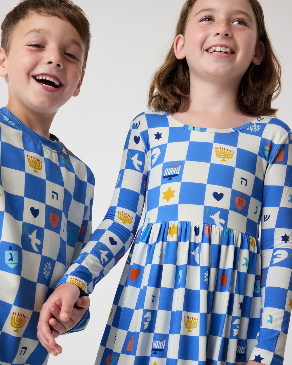 Two children wearing matching Hanukkah Checks Play styles