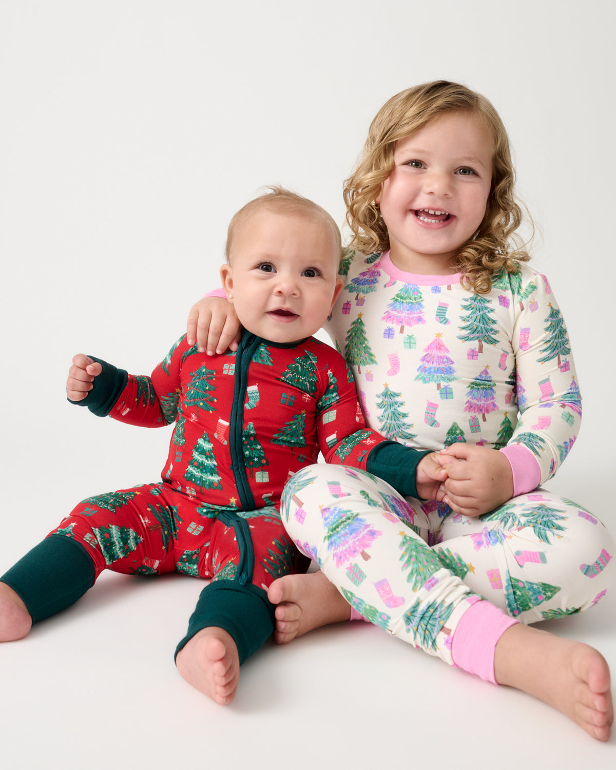 Two children wearing matching Joyful Traditions Holiday Pajamas 