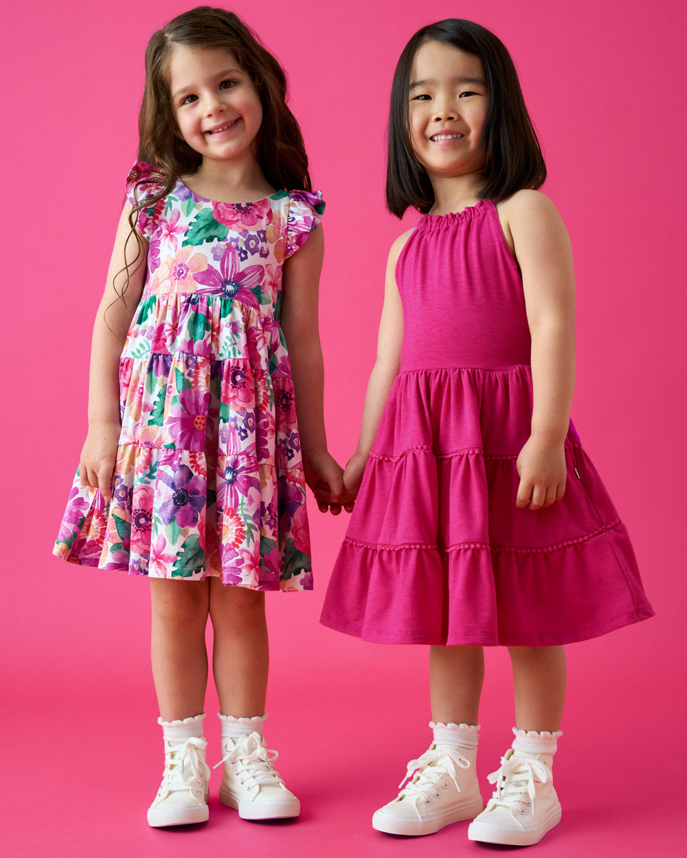Two girls wearing dresses from the Summer Capsule