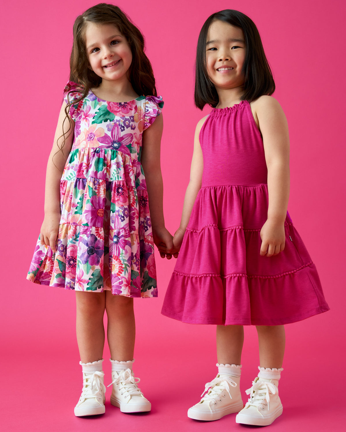 Two girls wearing dresses from the Summer Capsule