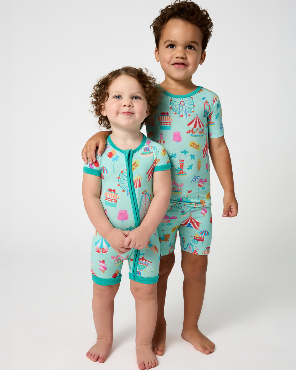 Two children wearing matching Fizzy Fair Pajamas