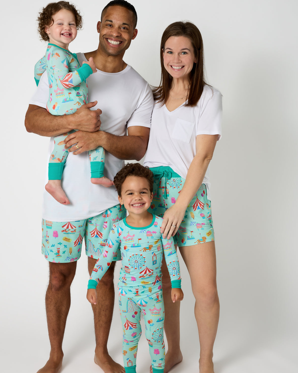 Family of four wearing Fizzy Fair Carnival themed pajamas