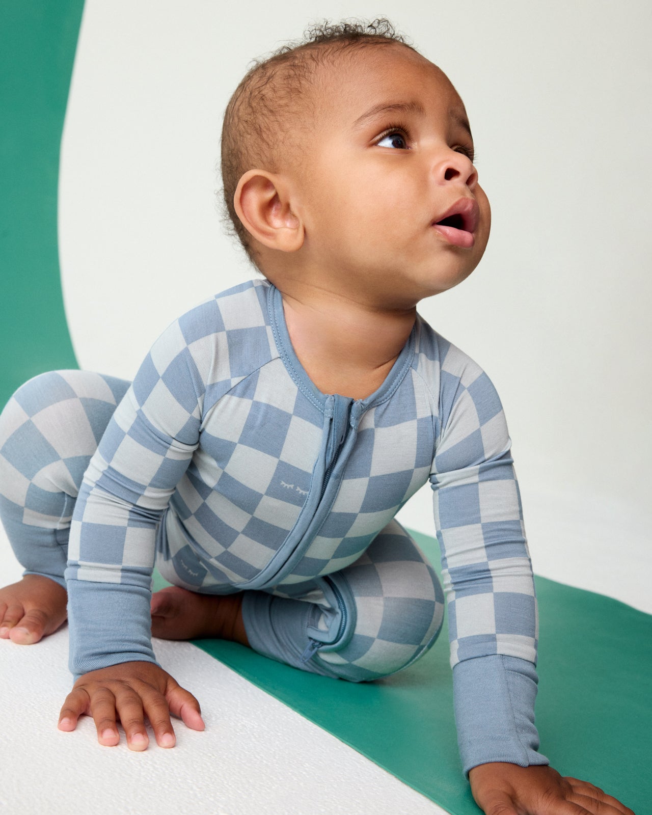 Crawling baby wearing the Dusk Blue Checks Zippy